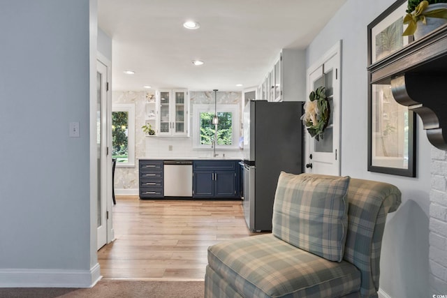 520 13th Ave N, Surfside Beach, SC 29575 - kitchen with appliances with stainless steel finishes, plenty of natural light, glass insert cabinets, light countertops, and recessed lighting
