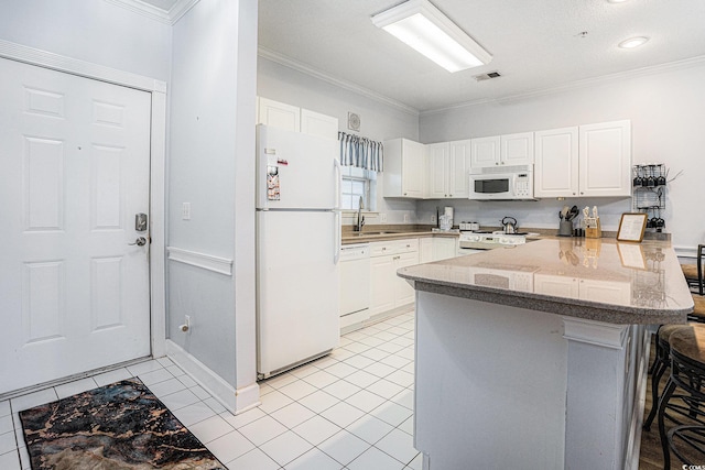 4868 Dahlia Ct Unit 202, Myrtle Beach, SC 29577 - kitchen with white appliances, a peninsula, a breakfast bar area, crown molding, and white cabinetry
