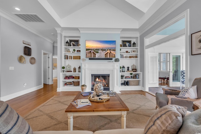 179 Cottage Ct, Pawleys Island, SC 29585 - living area featuring built in features, wood finished floors, a tile fireplace, ornamental molding, and recessed lighting