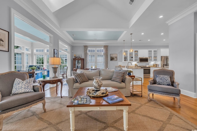 179 Cottage Ct, Pawleys Island, SC 29585 - living room featuring light wood-type flooring, ornamental molding, and recessed lighting
