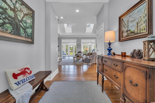 179 Cottage Ct, Pawleys Island, SC 29585 - corridor featuring wood finished floors, a tray ceiling, a skylight, and recessed lighting