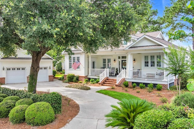179 Cottage Ct, Pawleys Island, SC 29585 - view of front of property with covered porch, driveway, and a garage