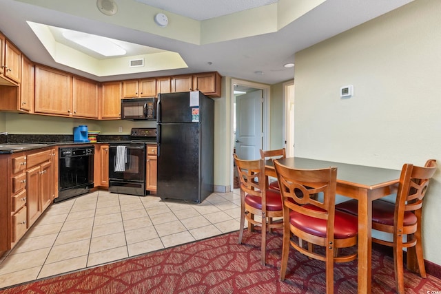 504 N Ocean Blvd Unit 1901, Myrtle Beach, SC 29577 - kitchen with black appliances, dark countertops, light tile patterned floors, and a raised ceiling