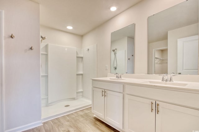 211 Seasons Trace Loop, Longs, SC 29568 - bathroom with walk in shower, double vanity, and wood finished floors