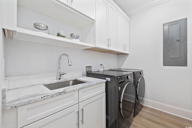 496 W Palm Dr, Myrtle Beach, SC 29579 - laundry room with electric panel, washing machine and dryer, cabinet space, light wood finished floors, and ornamental molding