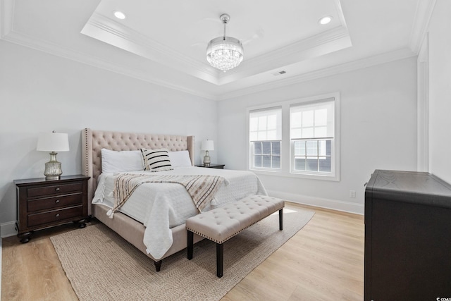 496 W Palm Dr, Myrtle Beach, SC 29579 - bedroom with light wood-style floors, a raised ceiling, a chandelier, crown molding, and recessed lighting