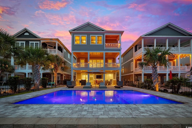496 W Palm Dr, Myrtle Beach, SC 29579 - rear view of house featuring a balcony, a patio area, and an outdoor living space
