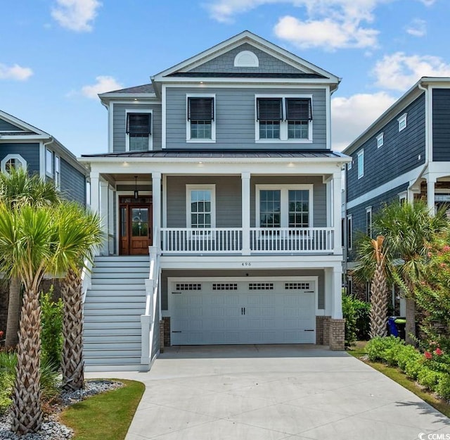 496 W Palm Dr, Myrtle Beach, SC 29579 - coastal home with a garage, concrete driveway, a standing seam roof, covered porch, and a metal roof