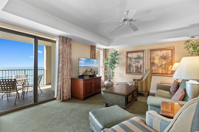 9994 Beach Club Dr Unit 1202, Myrtle Beach, SC 29572 - carpeted living area with ornamental molding, a tray ceiling, and a ceiling fan