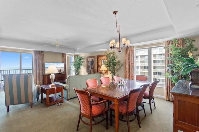 9994 Beach Club Dr Unit 1202, Myrtle Beach, SC 29572 - dining space with light colored carpet, a chandelier, ceiling fan, a raised ceiling, and a textured ceiling