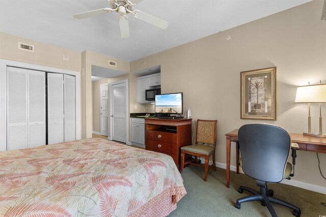 9994 Beach Club Dr Unit 1202, Myrtle Beach, SC 29572 - bedroom with light carpet, a desk, ceiling fan, and a closet