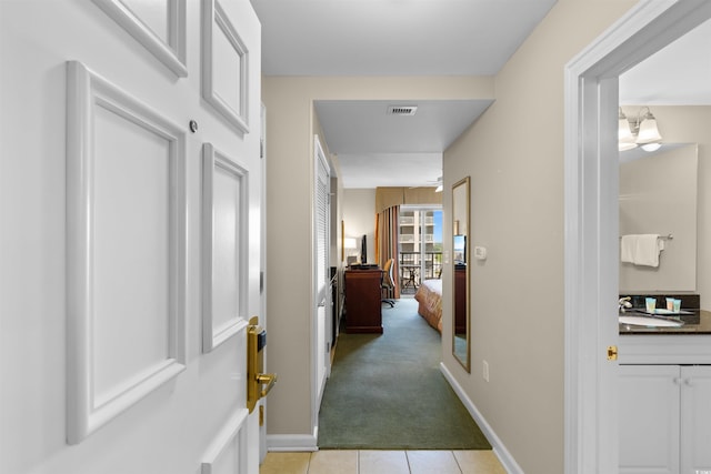 9994 Beach Club Dr Unit 1202, Myrtle Beach, SC 29572 - hallway featuring light tile patterned floors and light colored carpet