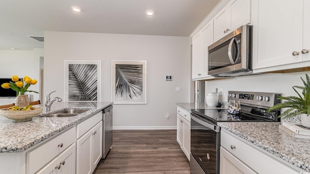 1407 Nokota Dr, Conway, SC 29526 - kitchen with stainless steel appliances, dark wood-style floors, white cabinetry, light stone counters, and recessed lighting