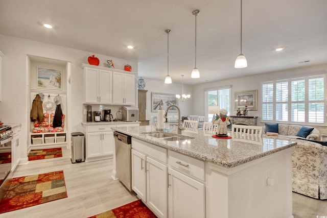 160 Juniata Loop, Little River, SC 29566 - kitchen with stainless steel dishwasher, light wood-style floors, white cabinets, a kitchen island with sink, and recessed lighting