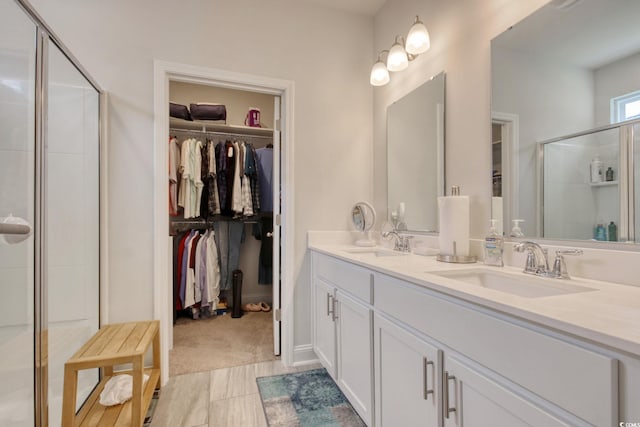 160 Juniata Loop, Little River, SC 29566 - bathroom featuring double vanity, a stall shower, and a spacious closet