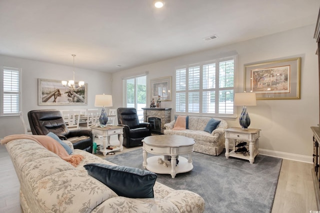 160 Juniata Loop, Little River, SC 29566 - living room with wood finished floors, a chandelier, and a stone fireplace