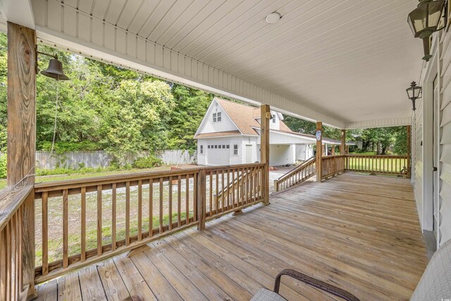 7288 Schooners Ct SW, Ocean Isle Beach, NC 28469 - wooden deck with an outdoor structure and a garage