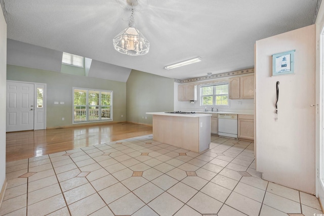 7288 Schooners Ct SW, Ocean Isle Beach, NC 28469 - kitchen with white appliances, open floor plan, light brown cabinetry, light countertops, and a center island