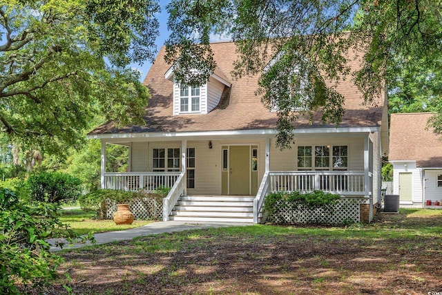 7288 Schooners Ct SW, Ocean Isle Beach, NC 28469 - new england style home with a porch
