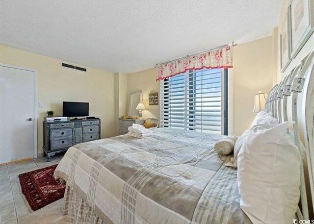 10200 Beach Club Dr Unit 16F, Myrtle Beach, SC 29572 - tiled bedroom with a textured ceiling