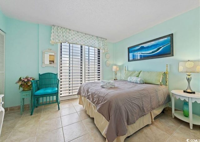 10200 Beach Club Dr Unit 16F, Myrtle Beach, SC 29572 - bedroom with light tile patterned floors and a textured ceiling