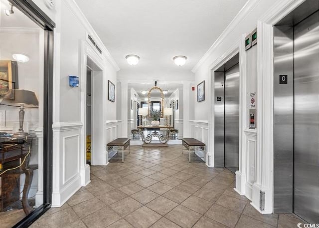 10200 Beach Club Dr Unit 16F, Myrtle Beach, SC 29572 - hallway featuring elevator, a decorative wall, crown molding, a wainscoted wall, and a chandelier