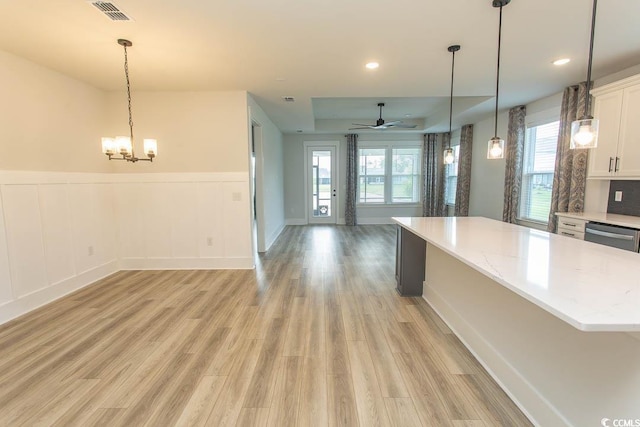 1514 Saw Palmetto St, North Myrtle Beach, SC 29582 - kitchen featuring open floor plan, a ceiling fan, white cabinets, a center island, and light wood-style floors