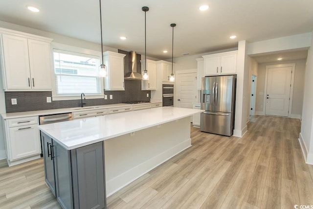 1514 Saw Palmetto St, North Myrtle Beach, SC 29582 - kitchen with appliances with stainless steel finishes, wall chimney exhaust hood, white cabinets, a large island, and light countertops