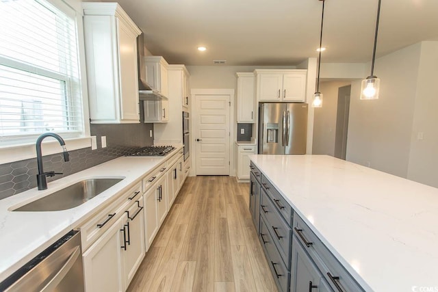1514 Saw Palmetto St, North Myrtle Beach, SC 29582 - kitchen with appliances with stainless steel finishes, gray cabinetry, light wood-type flooring, white cabinetry, and decorative light fixtures