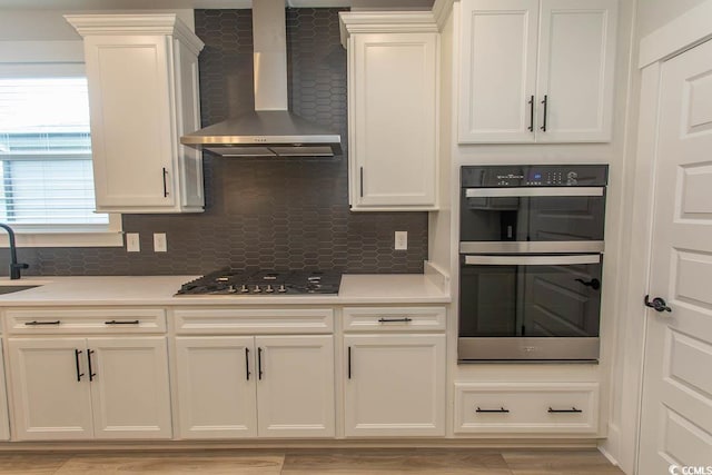 1514 Saw Palmetto St, North Myrtle Beach, SC 29582 - kitchen with wall chimney exhaust hood, stainless steel gas stovetop, and backsplash