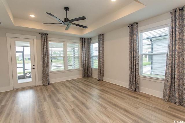 1514 Saw Palmetto St, North Myrtle Beach, SC 29582 - spare room with a tray ceiling, plenty of natural light, light wood-style floors, and recessed lighting