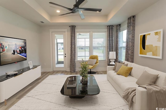 1514 Saw Palmetto St, North Myrtle Beach, SC 29582 - living room with a raised ceiling, ceiling fan, and light wood-type flooring