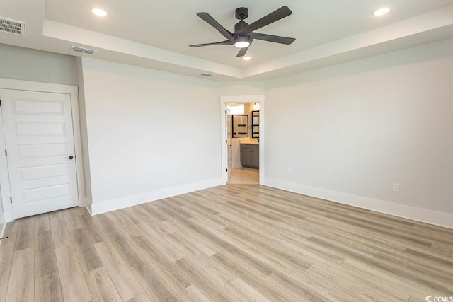 1514 Saw Palmetto St, North Myrtle Beach, SC 29582 - unfurnished room featuring a tray ceiling, recessed lighting, ceiling fan, and light wood-style floors