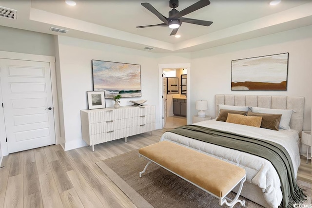 1514 Saw Palmetto St, North Myrtle Beach, SC 29582 - bedroom with a raised ceiling, light wood-style floors, recessed lighting, connected bathroom, and ceiling fan