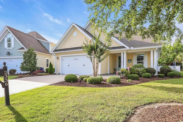 2336 Tidewatch Way N, Myrtle Beach, SC 29582 - view of front of home featuring driveway, a front lawn, a garage, and a porch