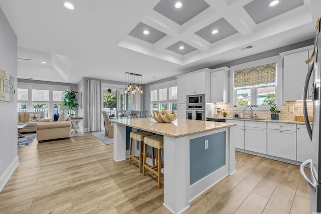 2336 Tidewatch Way N, Myrtle Beach, SC 29582 - kitchen featuring stainless steel appliances, a center island, white cabinetry, healthy amount of natural light, and coffered ceiling