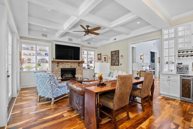 155 Preservation Cir, Pawleys Island, SC 29585 - living room with beverage cooler, bar, a fireplace, wood finished floors, and beamed ceiling