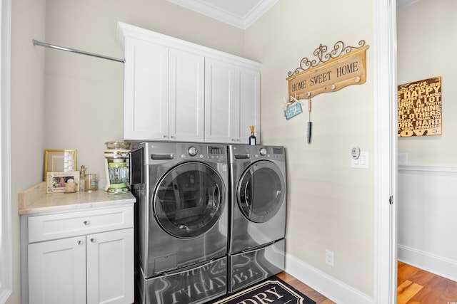 155 Preservation Cir, Pawleys Island, SC 29585 - laundry area featuring cabinet space, ornamental molding, independent washer and dryer, and wood finished floors