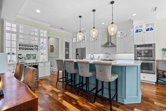 155 Preservation Cir, Pawleys Island, SC 29585 - kitchen featuring wall chimney exhaust hood, appliances with stainless steel finishes, ornamental molding, light countertops, and tasteful backsplash