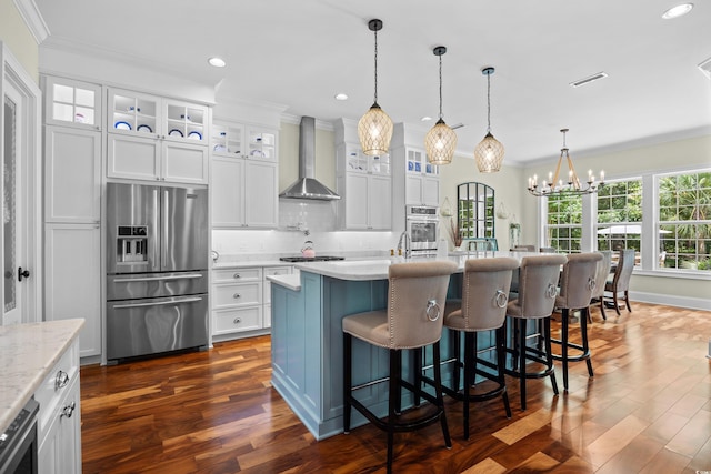 155 Preservation Cir, Pawleys Island, SC 29585 - kitchen with appliances with stainless steel finishes, wall chimney exhaust hood, crown molding, backsplash, and dark wood-style flooring