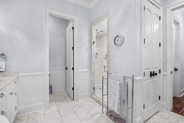 155 Preservation Cir, Pawleys Island, SC 29585 - bathroom featuring marble finish flooring, a shower stall, a wainscoted wall, vanity, and crown molding