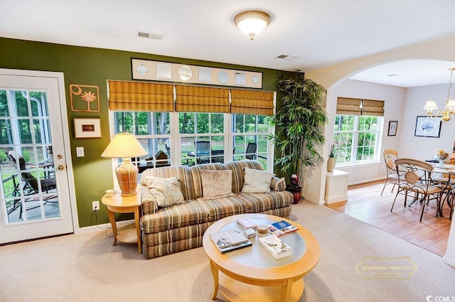 4570 Fringetree Dr, Murrells Inlet, SC 29576 - living room with arched walkways, a chandelier, and carpet flooring