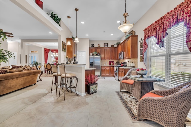 327 Trestle Way, Conway, SC 29526 - kitchen with appliances with stainless steel finishes, healthy amount of natural light, open floor plan, brown cabinets, and recessed lighting