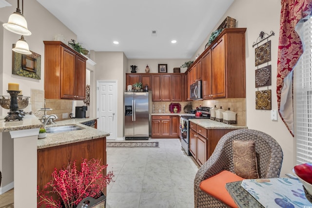 327 Trestle Way, Conway, SC 29526 - kitchen featuring appliances with stainless steel finishes, tasteful backsplash, a peninsula, recessed lighting, and light stone counters