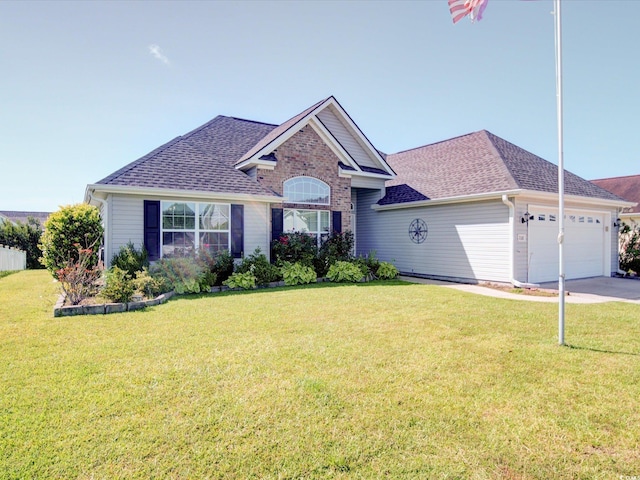 708 Shenanigan Loop, Murrells Inlet, SC 29576 - view of front facade featuring a garage, a shingled roof, a front yard, and driveway