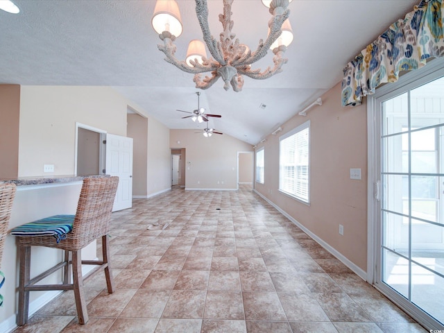 708 Shenanigan Loop, Murrells Inlet, SC 29576 - unfurnished living room with vaulted ceiling, a ceiling fan, and a chandelier