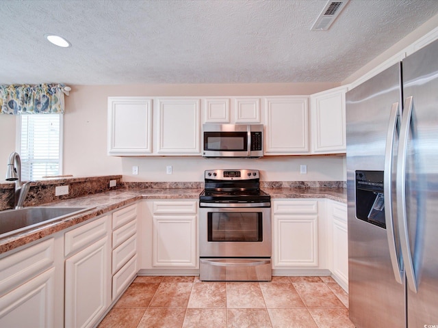 708 Shenanigan Loop, Murrells Inlet, SC 29576 - kitchen featuring stainless steel appliances, a textured ceiling, white cabinetry, stone countertops, and recessed lighting