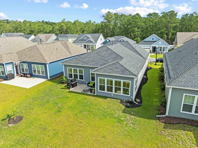 6304 Chadderton Cir, Myrtle Beach, SC 29579 - back of property with a patio, roof with shingles, and a lawn
