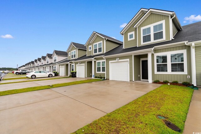 623 Harrison Mill St Unit 623, Myrtle Beach, SC 29579 - townhome / multi-family property with board and batten siding, driveway, a residential view, an attached garage, and a front lawn
