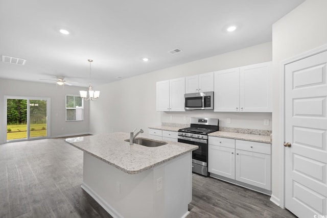 623 Harrison Mill St Unit 623, Myrtle Beach, SC 29579 - kitchen with appliances with stainless steel finishes, white cabinets, a center island with sink, dark wood-type flooring, and hanging light fixtures